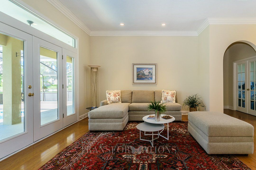 A living room with a sectional couch and a rug