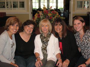 A group of women are posing for a picture together