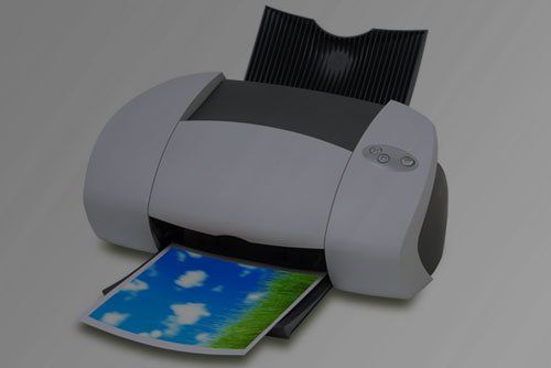 a printer is printing a picture of a cloudy sky .