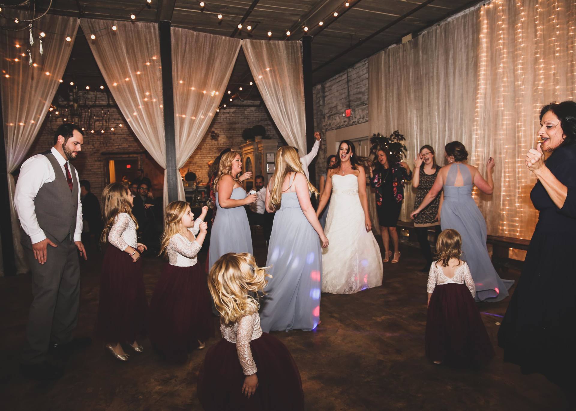 bride and her bridesmaids dancing
