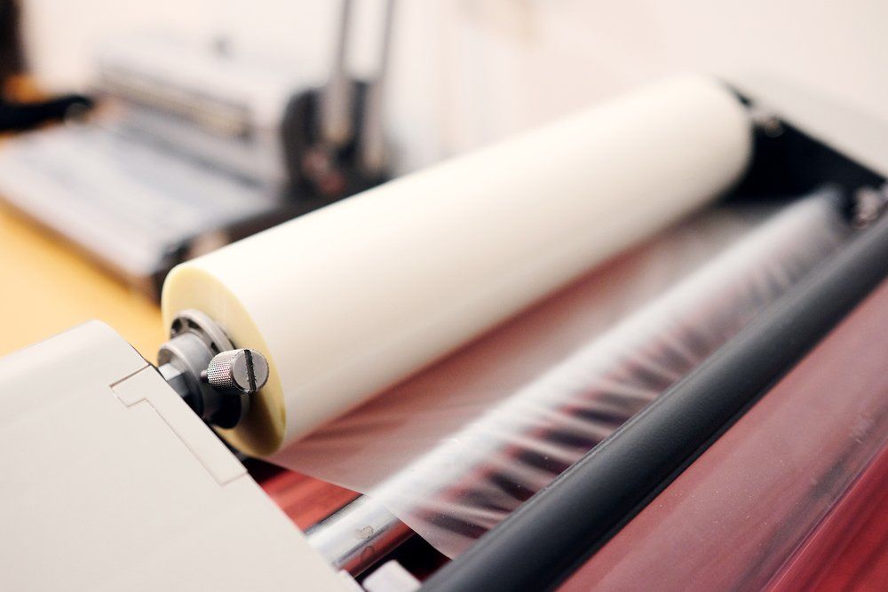 Lamination machine showing plastic sheeting on a roll
