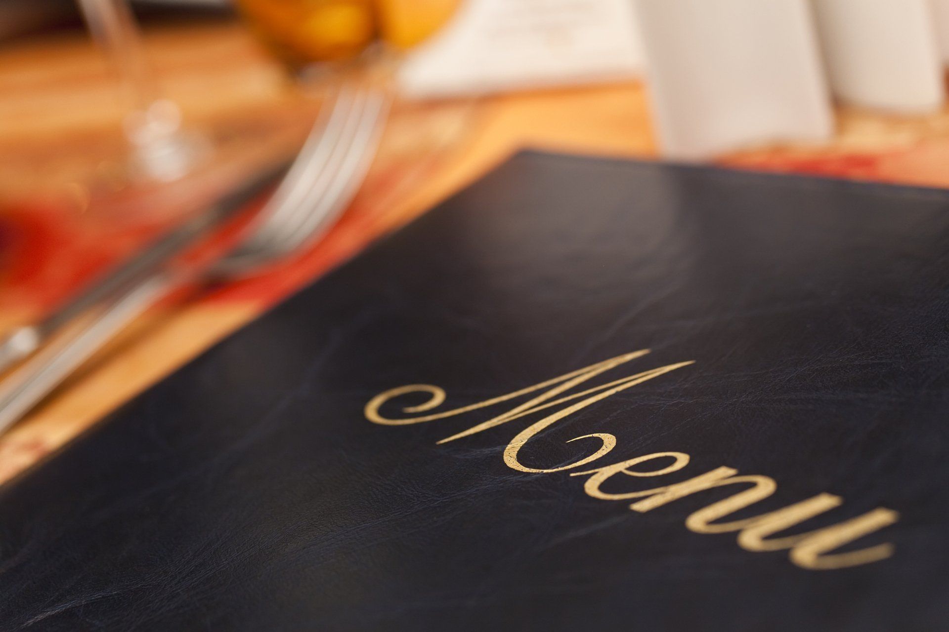 Menu cover with title written in gold on dark background