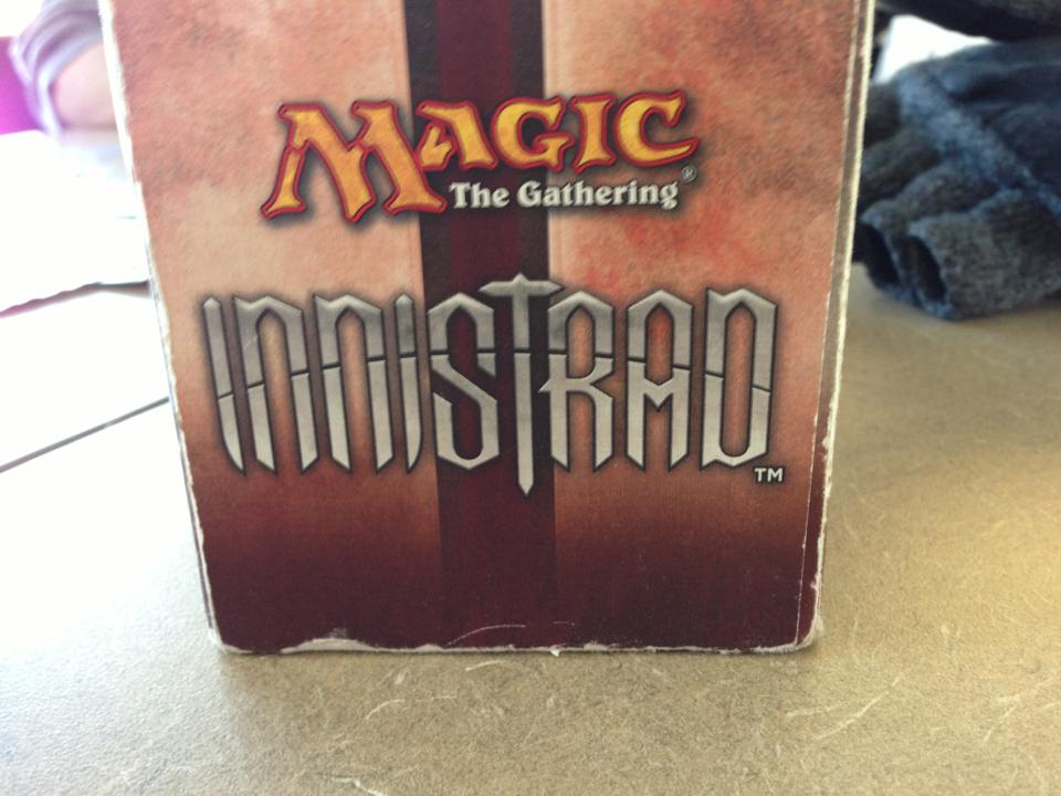 a box of magic the gathering cards sits on a table