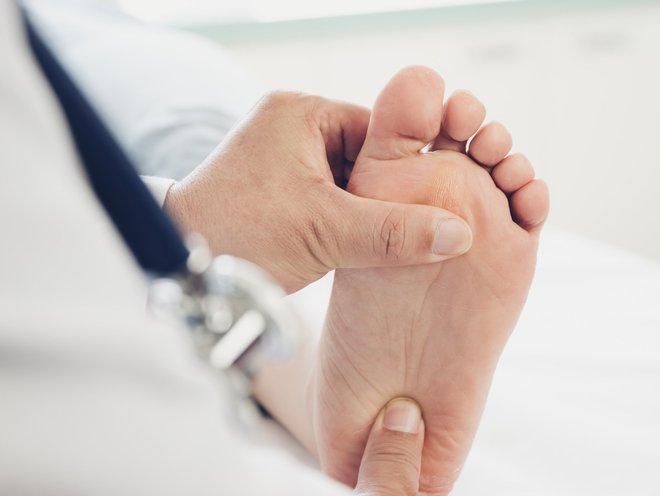 Doctor giving a patient foot treatment