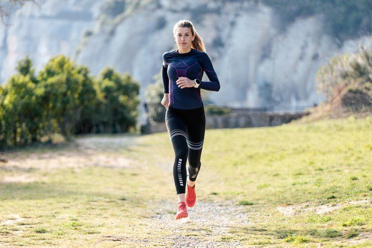 Sporty young woman running in nature