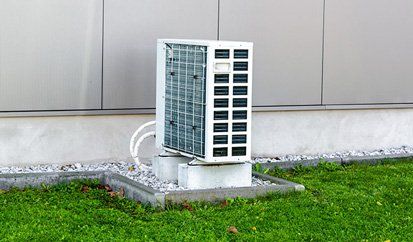 Heat Pump Unit Outside The Residential House - System Maintenance in Franklin, North Carolina Heat Pump Unit Outside The Residential House - System Maintenance in Franklin, North Carolina