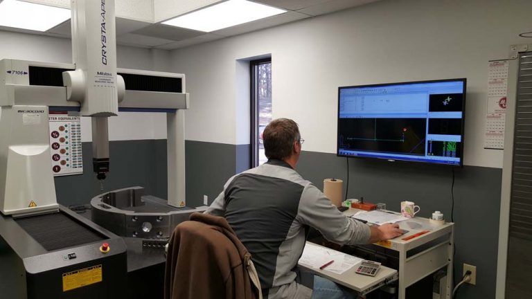 Man using a computer to drill precision holes