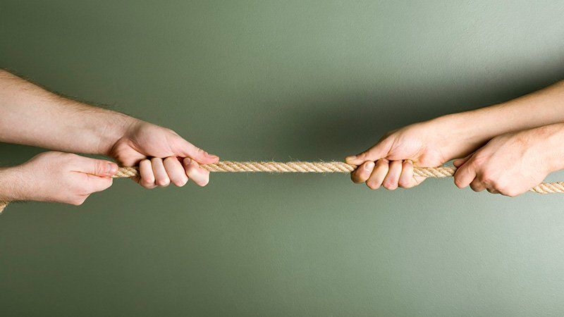 two people tugging on a rope