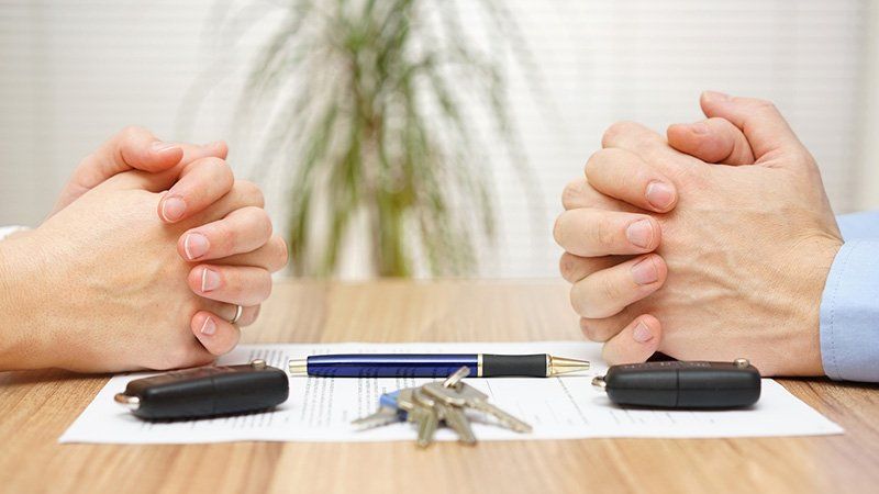 Folded hands on a contract