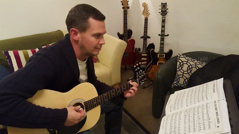 A guitar student practising