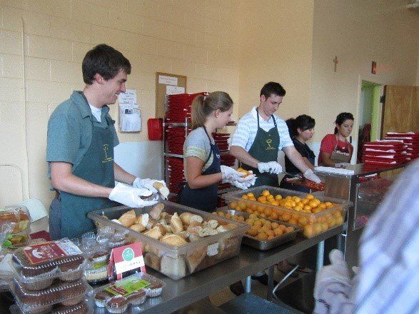A line of volunteers at a soup kitchen
