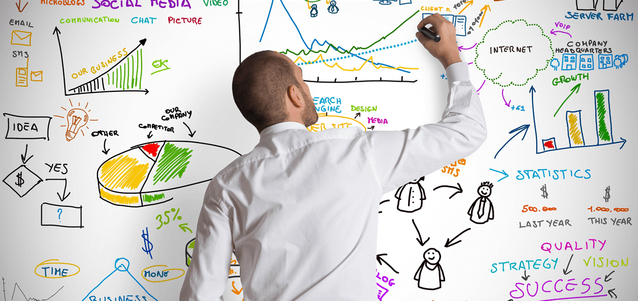 A professional writing notes and graphics on a white board