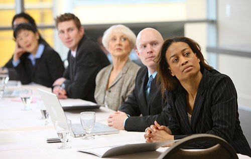 A team listening to a presentation in a corporate boardroom