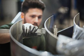 worker bending steel sheets
