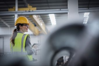 woman standing in steel warehouse