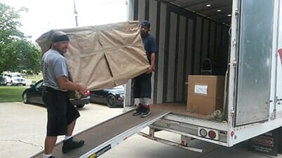 Man Carrying Cardboard Box — Packing Services in Netcong, NJ
