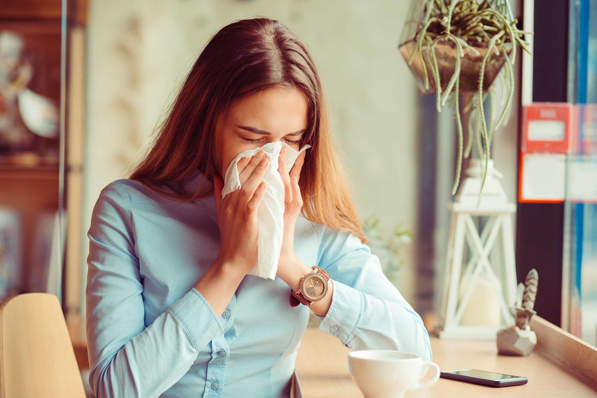 woman blowing her nose
