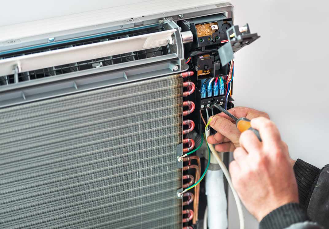 AC Repairs — Man Repairing the Air Condition in Sandy, UT AC Repairs — Man Repairing the Air Condition in Sandy, UT