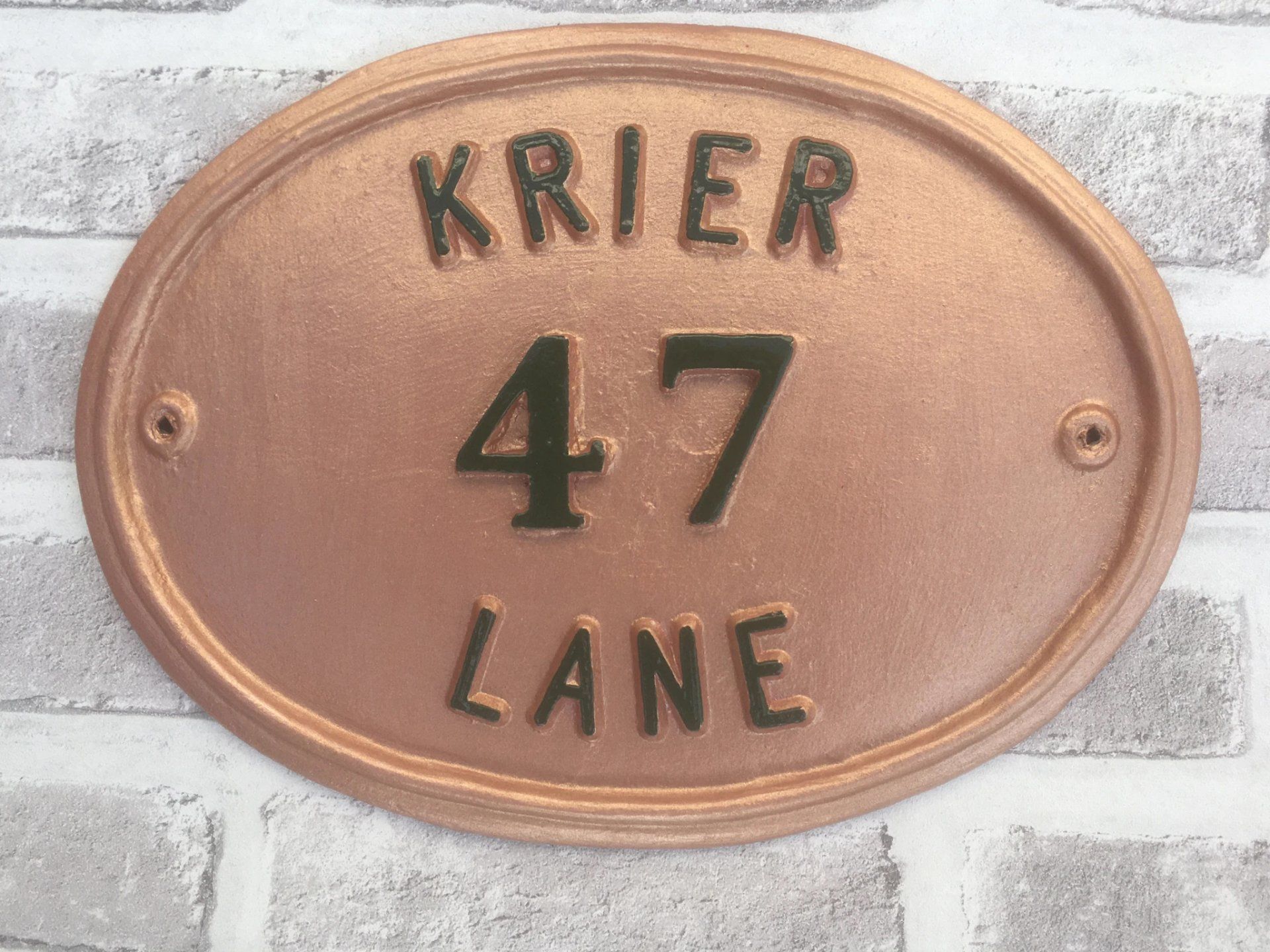 House sign in bronze