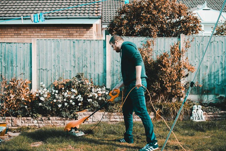 Gardener landscaper professionally treating lawn hitchin