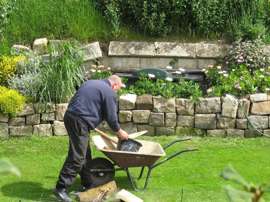 Landscaper working on wall repairs hitchin