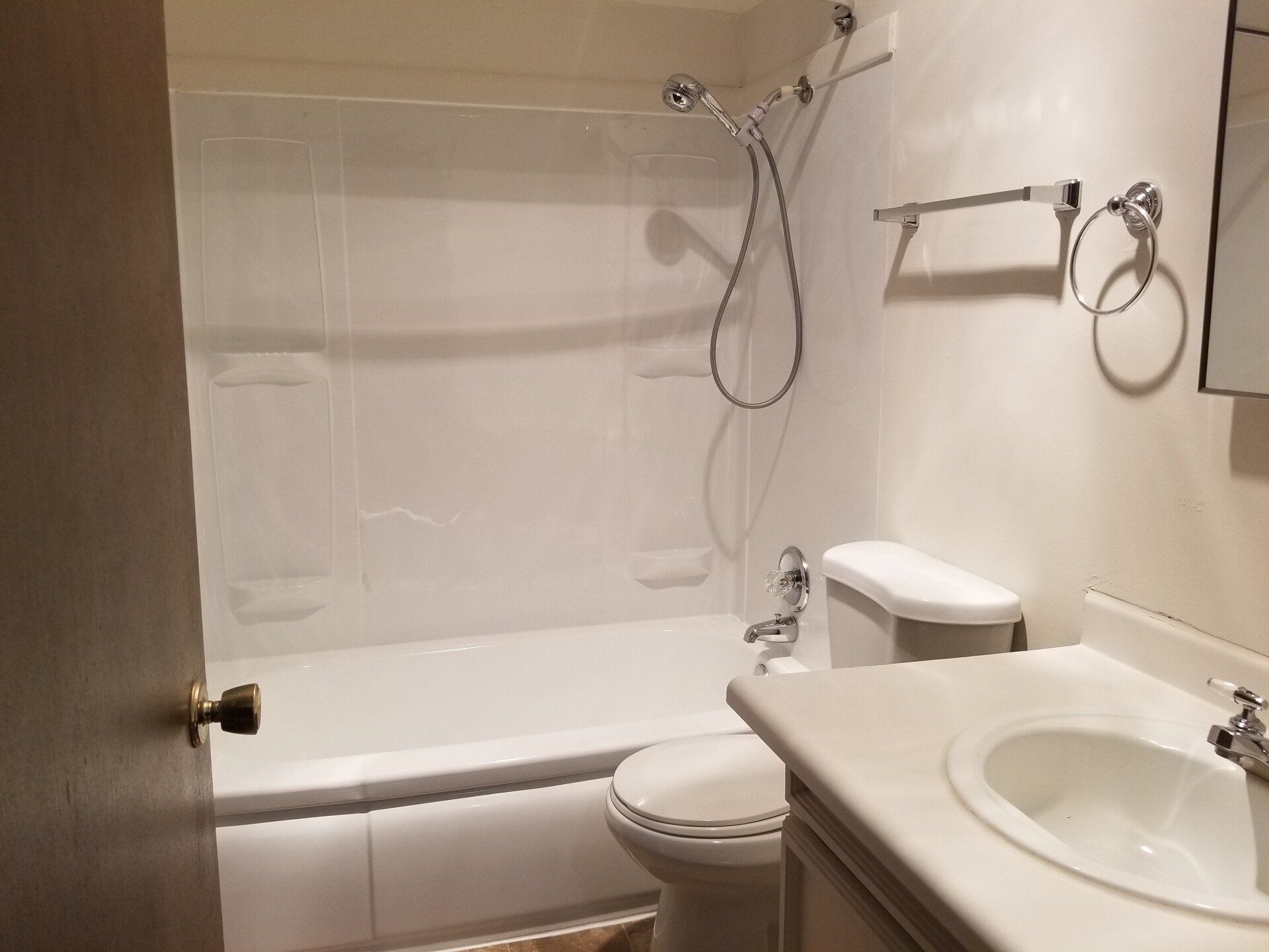 A bathroom with a toilet , sink and bathtub