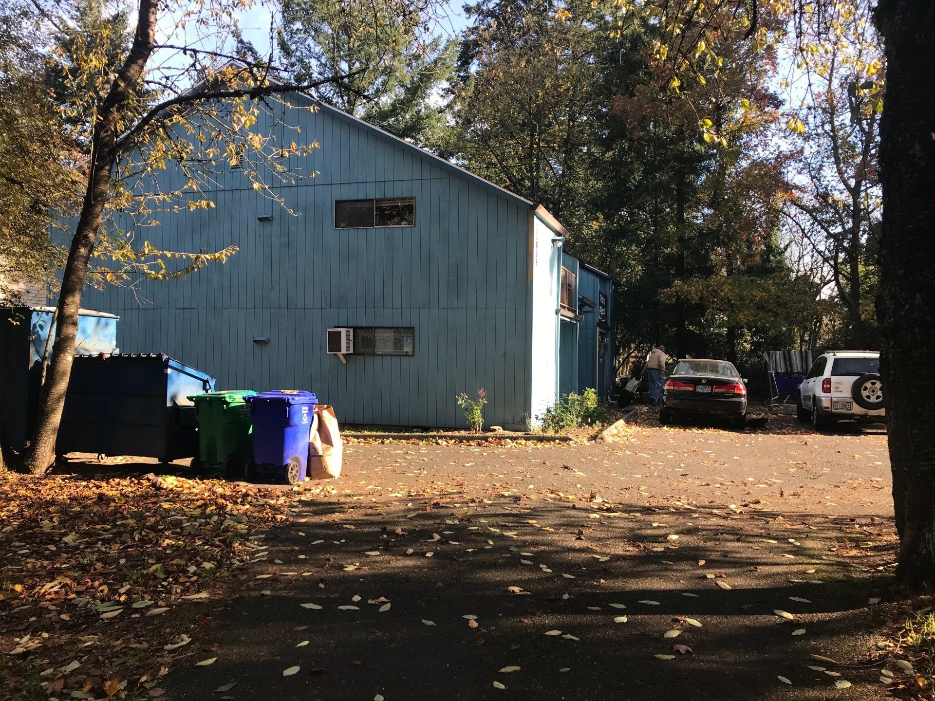 A blue building with cars parked in front of it
