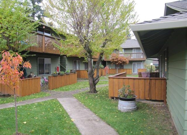 A row of houses with a walkway between them.