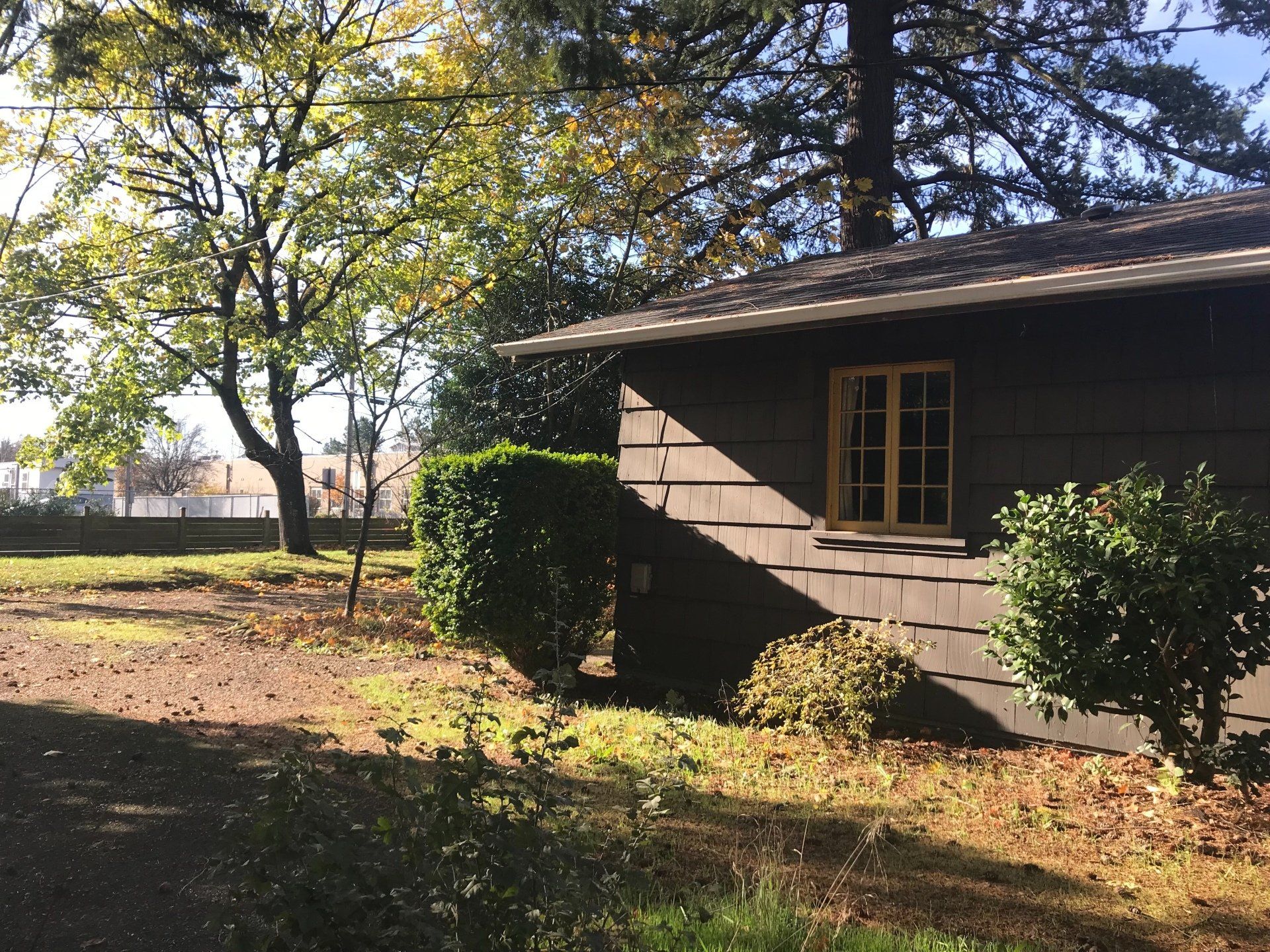 A house with a window and trees in the background