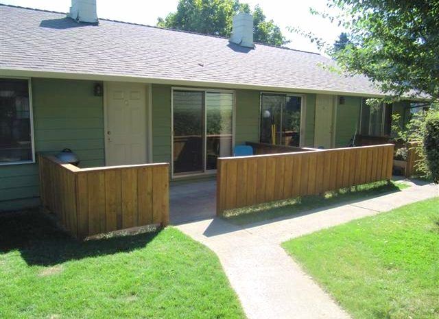 A house with a wooden fence around it