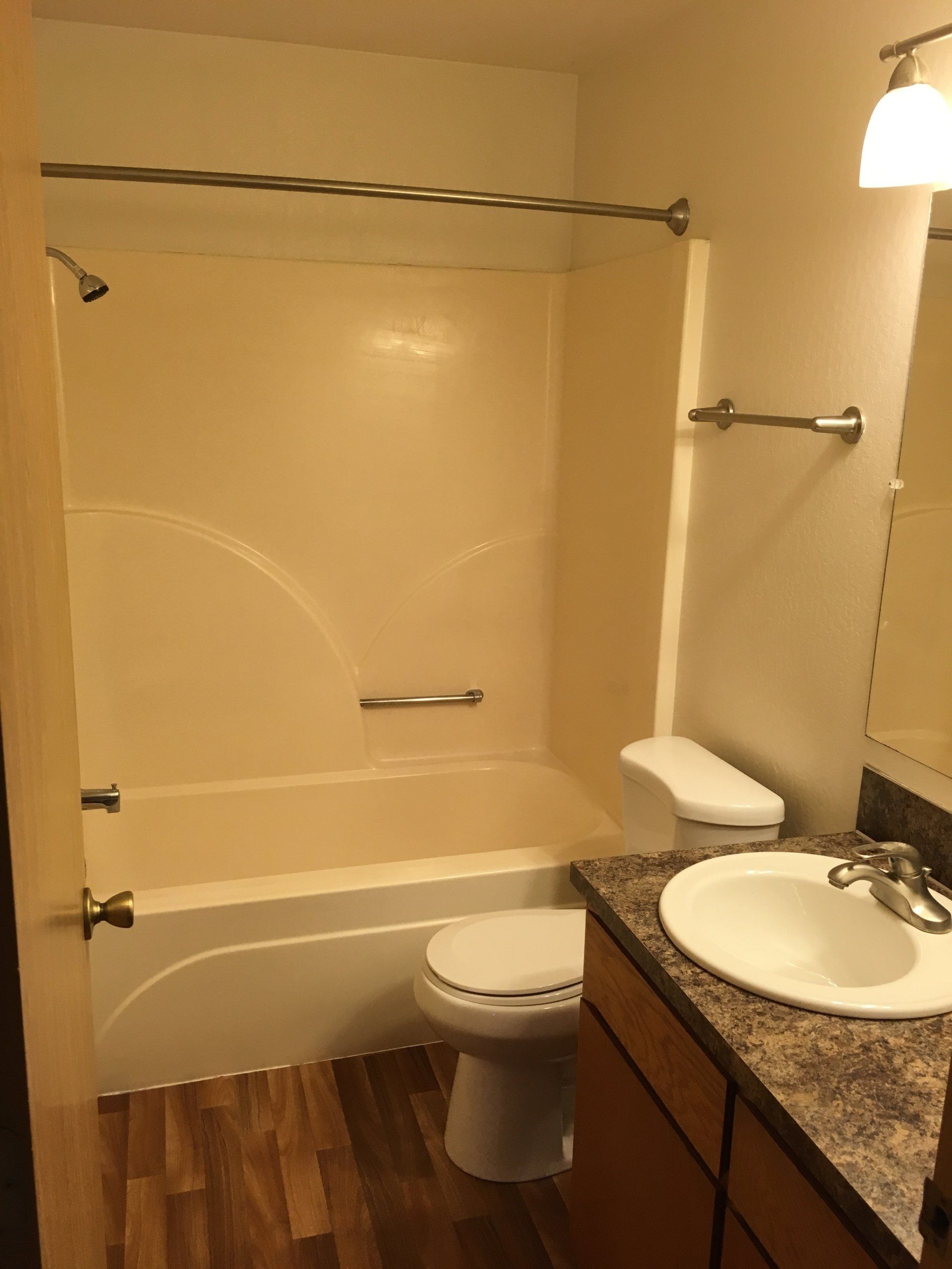 A bathroom with a toilet , sink and bathtub