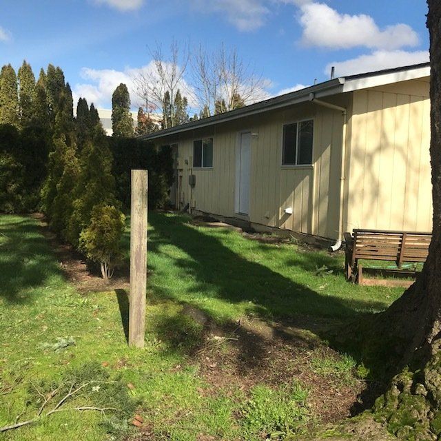 A house with a wooden bench in front of it