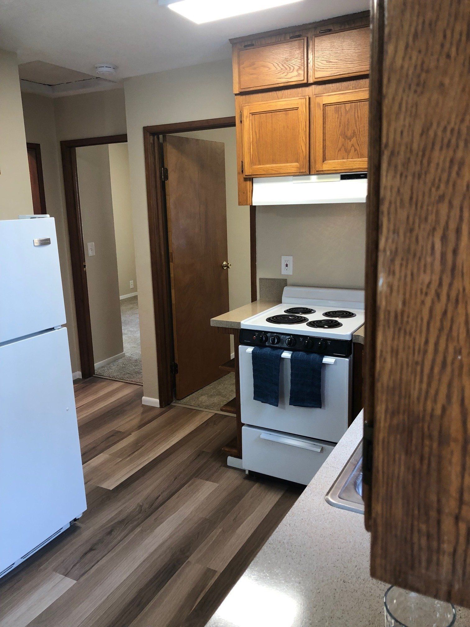 A kitchen with a stove and a refrigerator in it