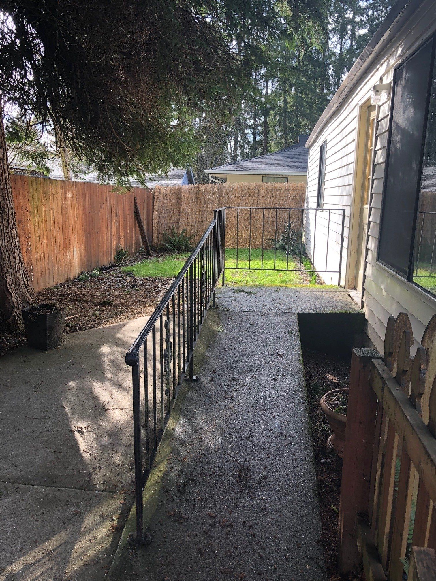 There is a ramp leading to the backyard of a house.