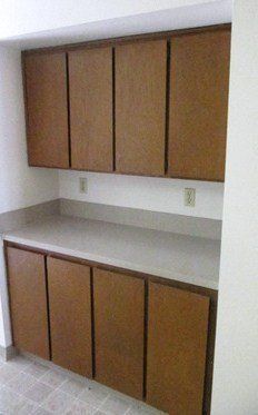 A kitchen with wooden cabinets and a counter top.
