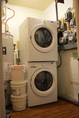 A washer and dryer are stacked on top of each other in a laundry room.
