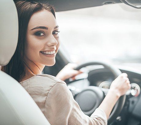 Auto Insurance Service — Woman Smiling Inside Car in Bountiful, UT Auto Insurance Service — Woman Smiling Inside Car in Bountiful, UT