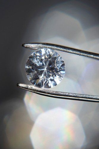 Diamond held by tweezers- Jewelry Services in Saratosa, FL Diamond held by tweezers- Jewelry Services in Saratosa, FL