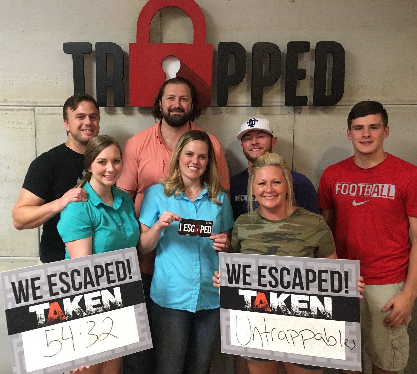 A group of people holding signs that say we escaped taken