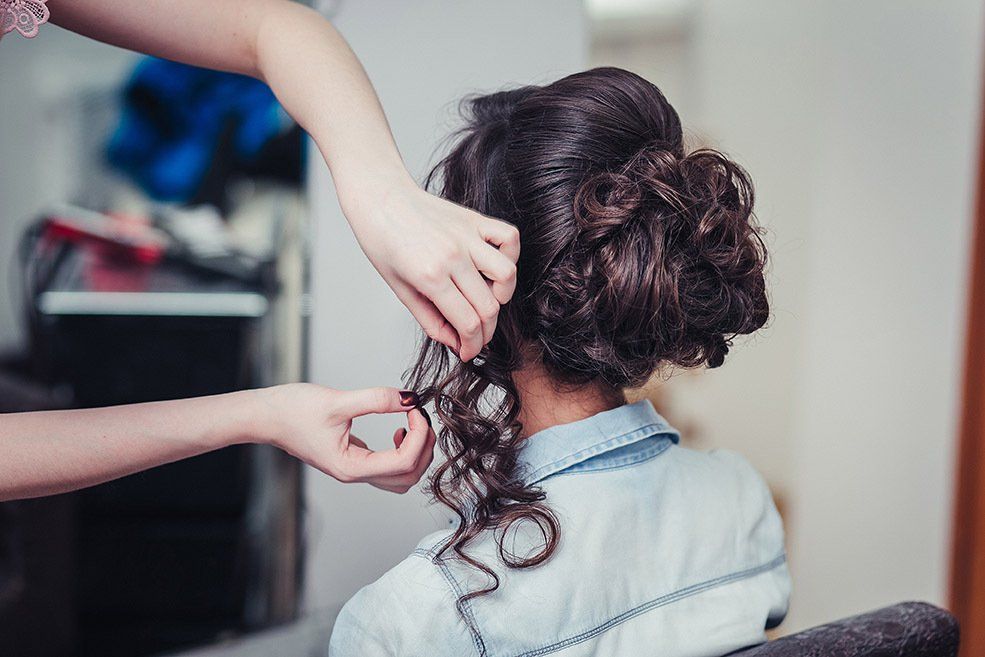 Hairdresser Fixing Woman Hair — Hair Salon in Townsville, QLD