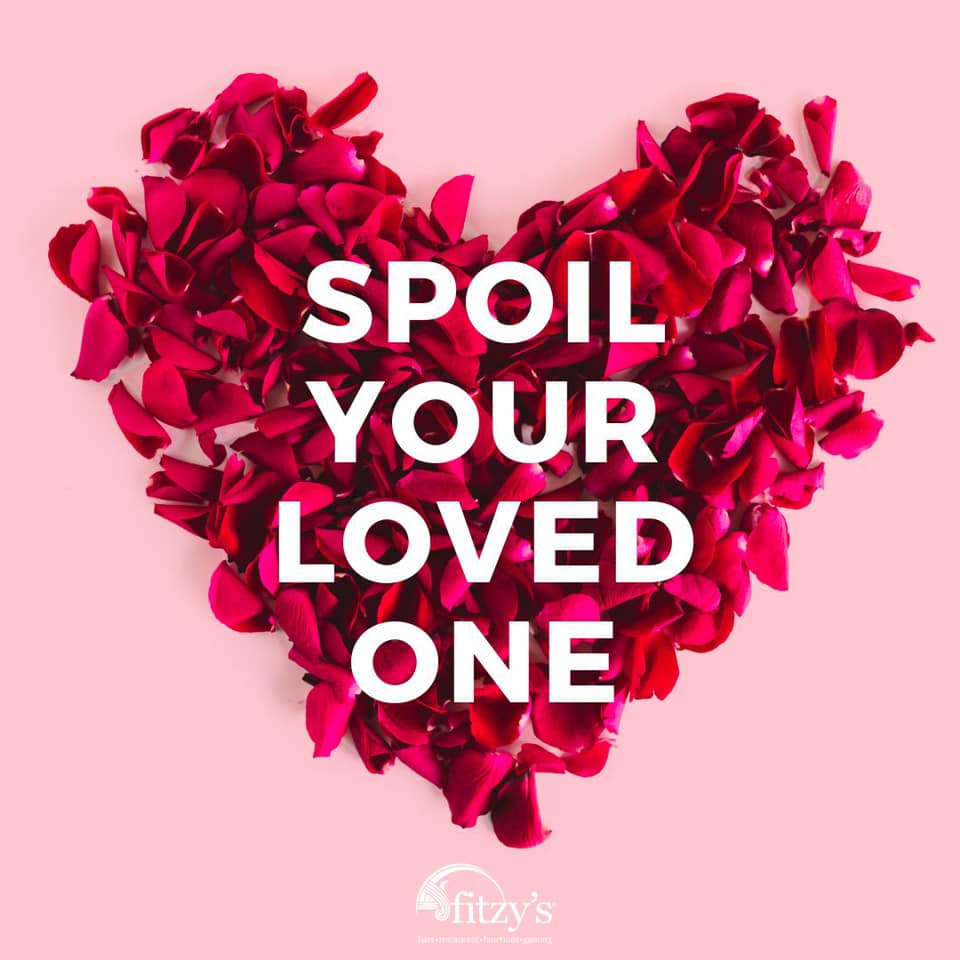 A heart made of rose petals with the words spoil your loved one
