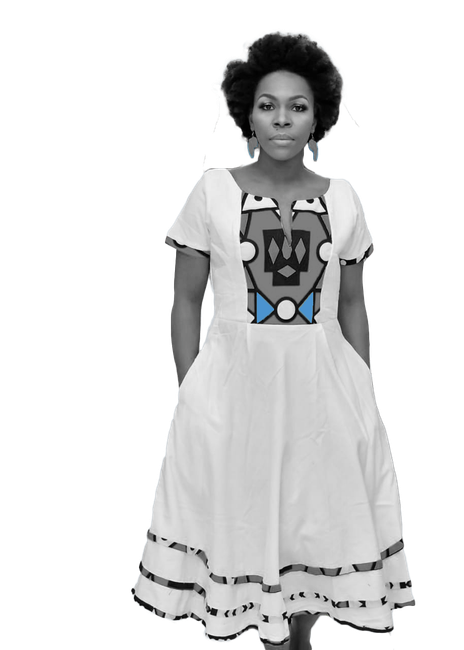A black and white photo of a woman in a white dress