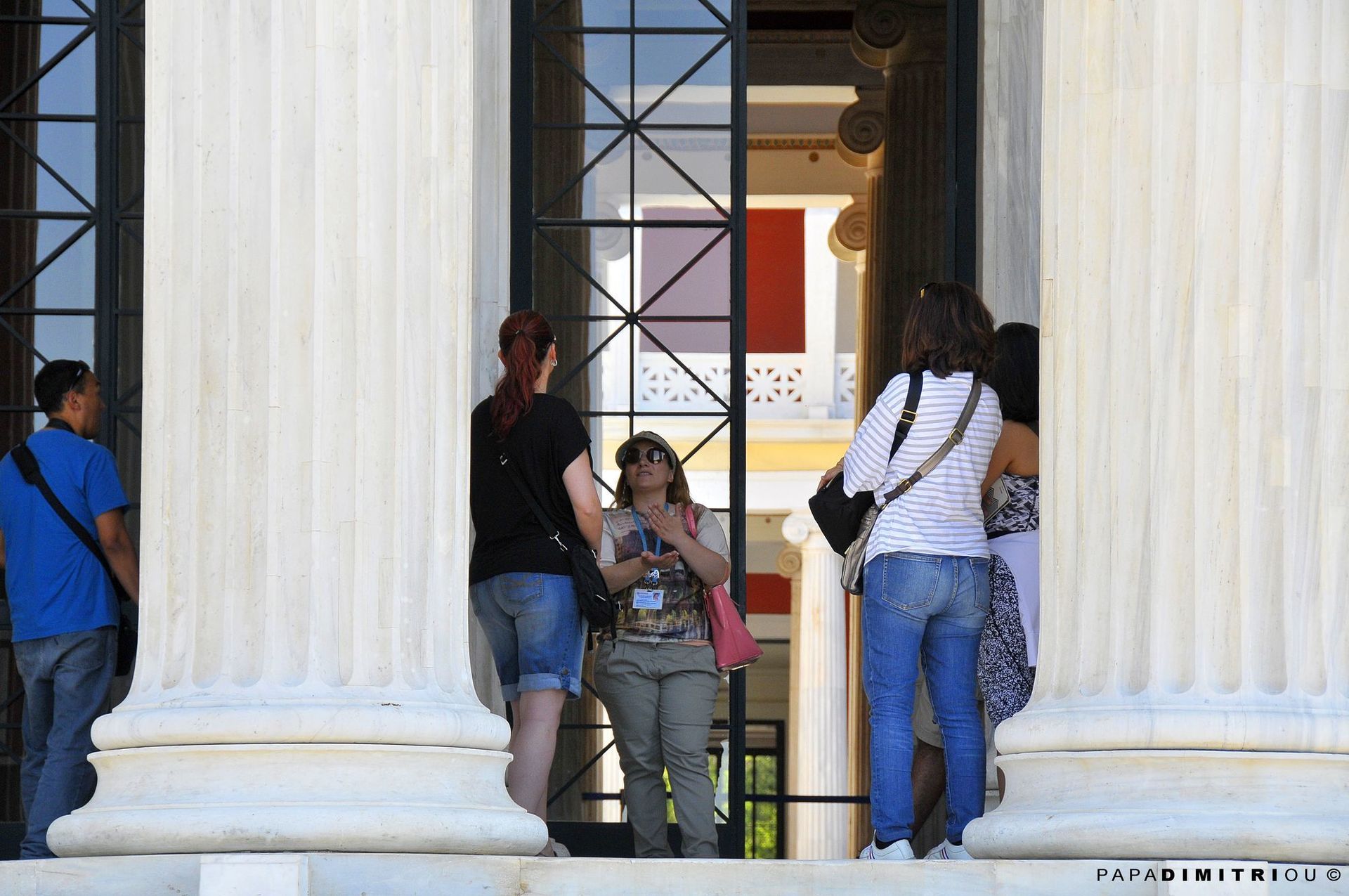 A guide leading a group of tourists at Zappeion in Athens.