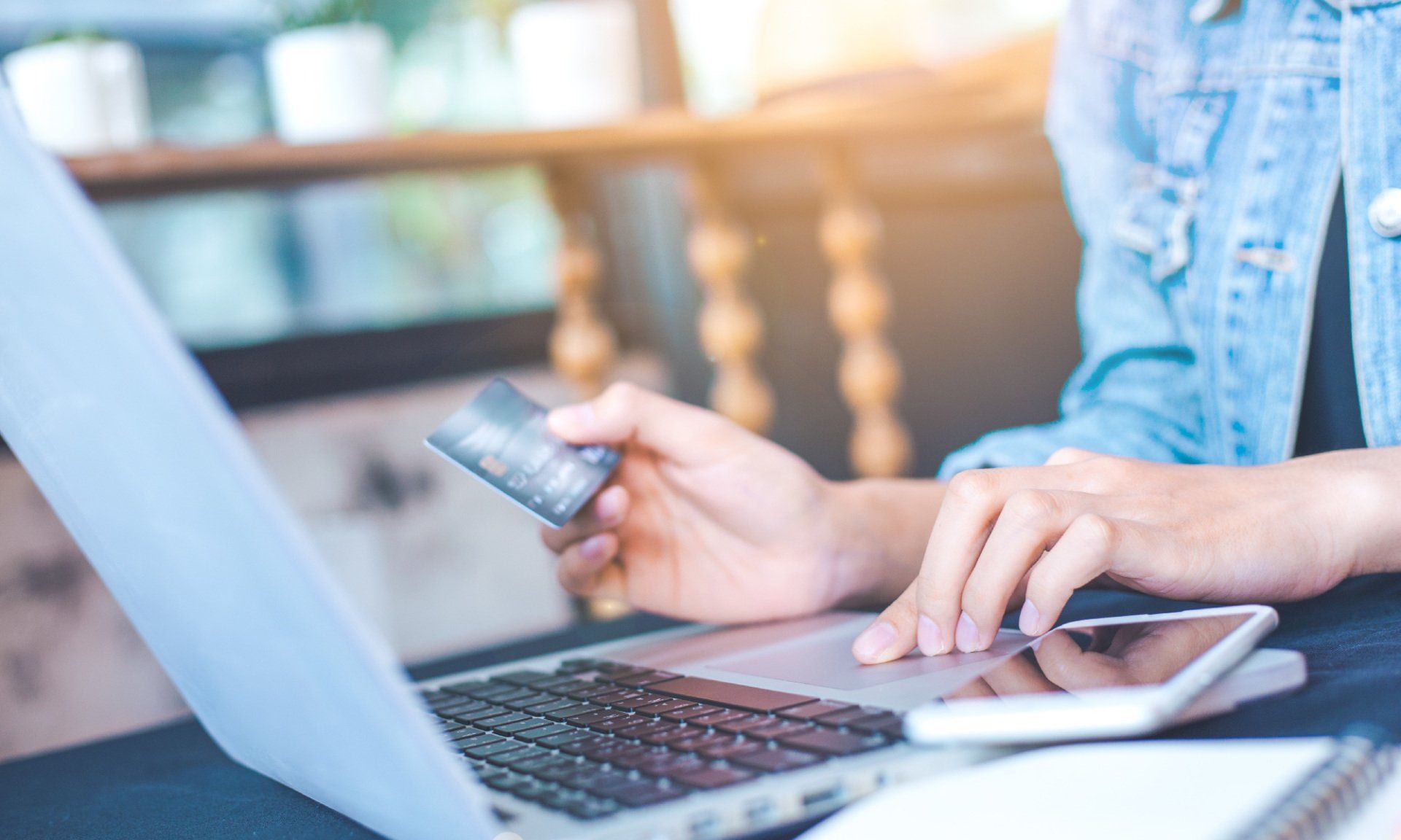 man using credit card while on laptop
