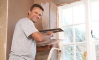 Plasterer repairing wall