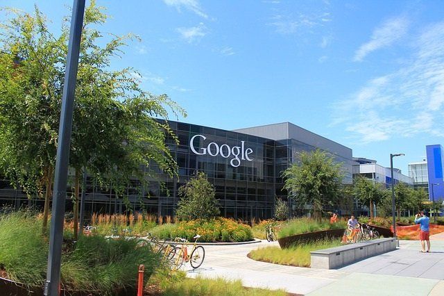 A large google building with a bicycle parked in front of it.