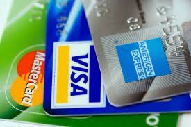 Three credit cards are stacked on top of each other.