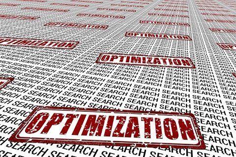 The word optimization is on a piece of paper