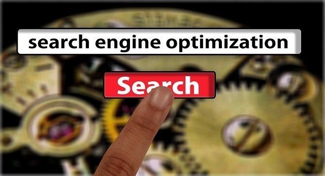 A person is pointing at a search engine optimization button