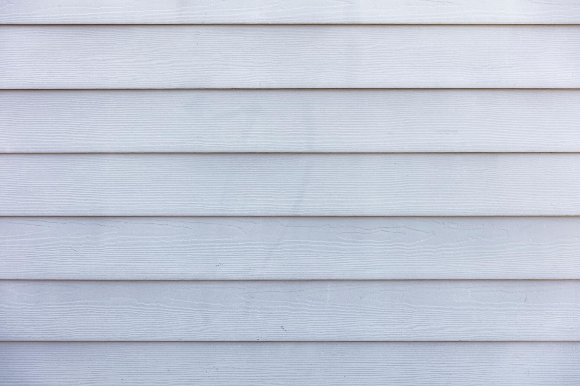 Light gray horizontal siding with a subtle wood grain texture.